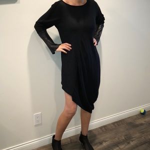 Black cocktail dress with leather cuffs.